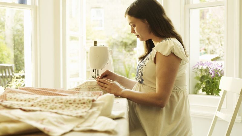pregnant woman sewing